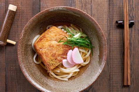  Kitsune Udon: Un mariage délicieux de bouillon umami et de douce saveur de tofu frit !